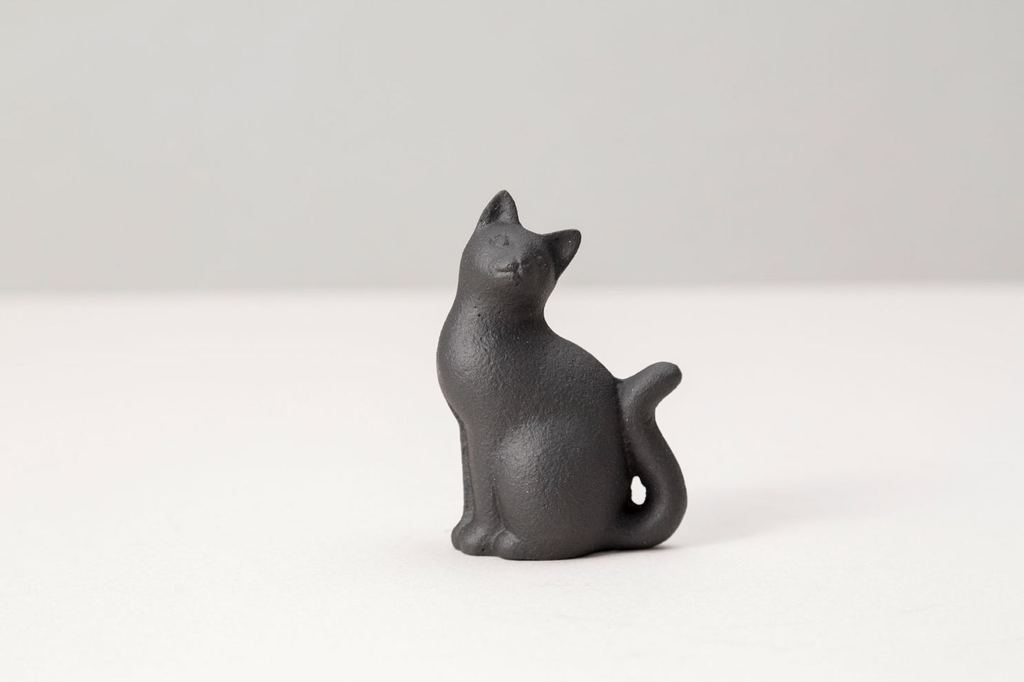paperweight long-tailed cat 