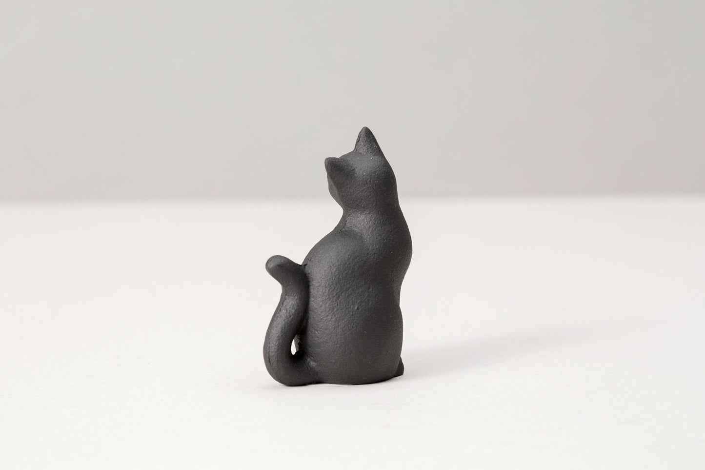 paperweight long-tailed cat 